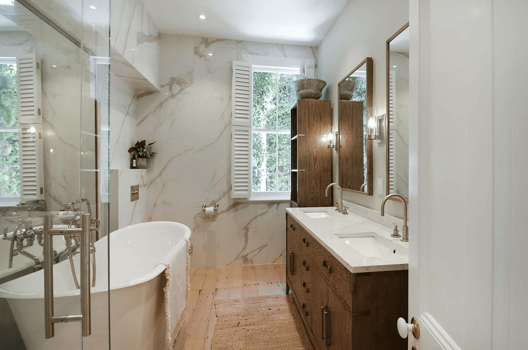 Luxurious bathroom with marble-look tiles and freestanding bathtub